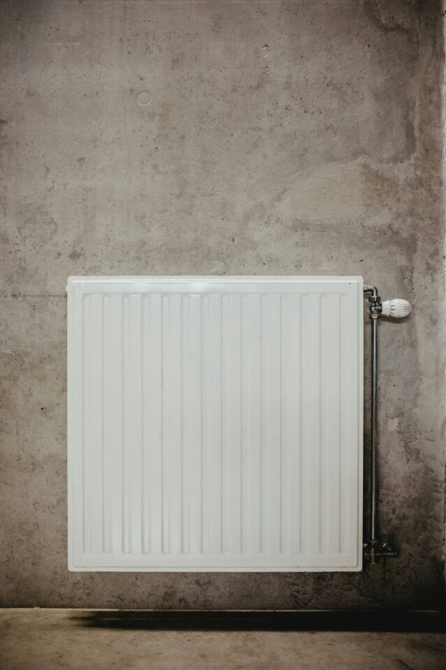 White radiator against concrete wall